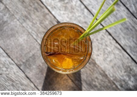 Healthy, Refreshing Drink Of Cinnamon And Stalks Of Lemongrass On A Wooden Table, Top View