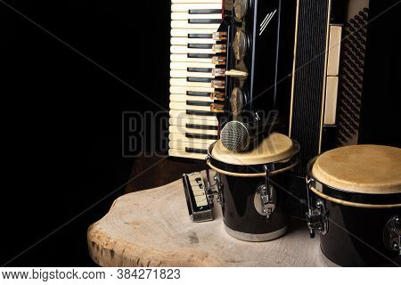 Old Accordion, Harmonica, Bong And Microphone On A Rustic Wooden Surface With Black Background And L