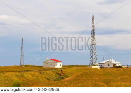 Arnarstapi, Iceland- 26 August 2015: White Buildings And High Relay Poles On Snaefellsnes Peninsula.