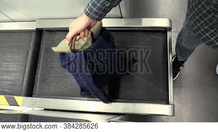 Mans Hand With A Backpack On Luggage Conveyor Belt System At Check In Desk In Airport. Blue Backback