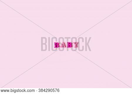 The Word Baby Is Made Of Wooden Letters On A Pale Pink Background. Banner Design. Baby Shower Concep