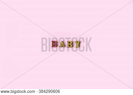The Word Baby Is Made Of Wooden Letters On A Pale Pink Background. Banner Design. Baby Shower Concep