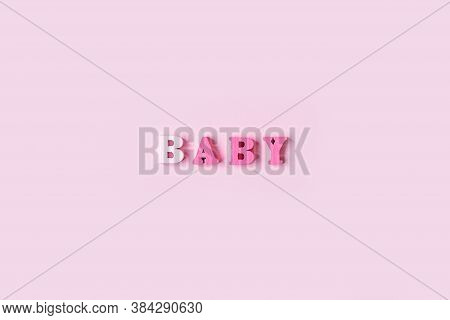 The Word Baby Is Made Of Wooden Letters On A Pale Pink Background. Banner Design. Baby Shower Concep
