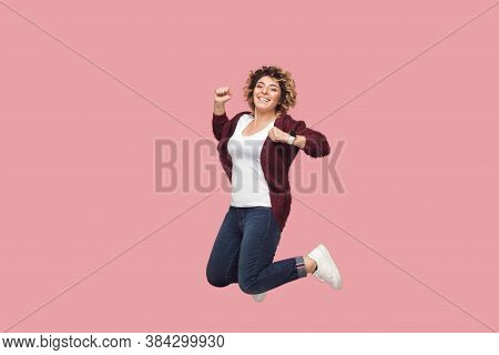 Full Length Portrait Of Young Happy Woman With Curly Hairstyle In White Shirt Jumping, Cheering, Cel