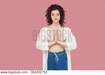 Portrait Of Calm Relaxed Beautiful Brunette Young Woman With Curly Hairstyle In Casual Style Standin