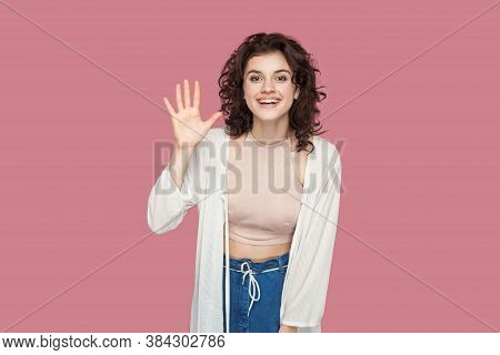 Hi, Glad To See You. Portrait Of Happy Satisfied Beautiful Brunette Young Woman With Curly Hairstyle