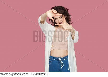 Portrait Of Beautiful Brunette Young Woman With Curly Hairstyle In Casual Style Standing And Looking