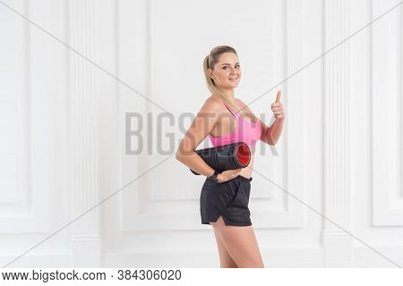 Sporty Concept. Satisfied Athletic Young Beautiful Blonde Girl In Pink Top And Black Shorts Standing