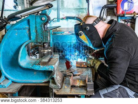Electric Welding Process. Worker In Welding Mask.  Bright White And Blue.