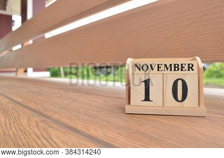 November 10, Number Cube With Wooden Balcony Background.
