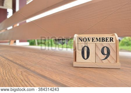 November 9, Number Cube With Wooden Balcony Background.