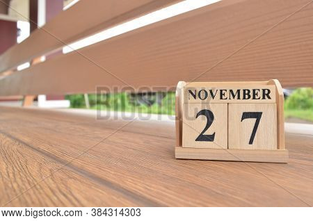 November 27, Number Cube With Wooden Balcony Background.