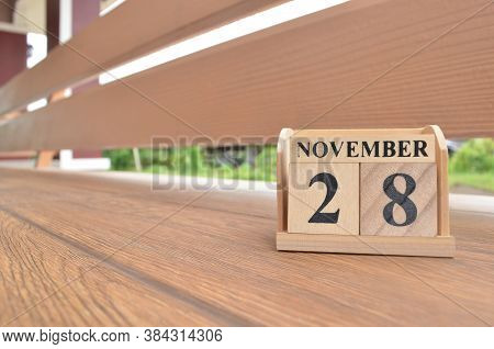 November 28, Number Cube With Wooden Balcony Background.