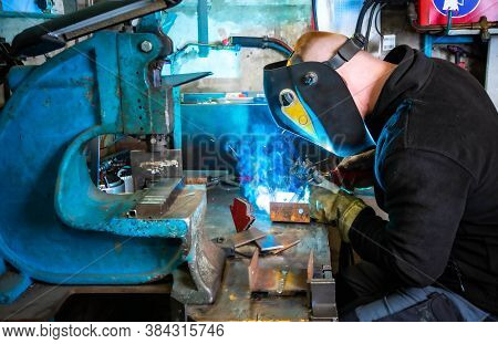 Electric Welding Process. Worker In Welding Mask. Bright White And Blue.