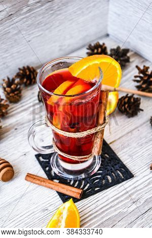 Christmas Mulled Wine With And Orange On Wooden Rustic Background. Selective Focus. Anise Stars And 