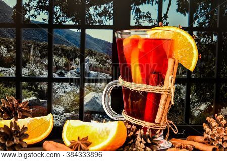 Mulled Wine Hot Christmas Drink With On A Windowsill, Next To The Window. Orange Slices, Cinnamon St
