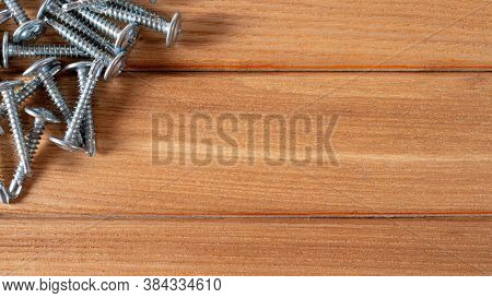 Self-cutters On A Wood Brown Background Banner With Space For Text. Construction Tools, Self-tapping