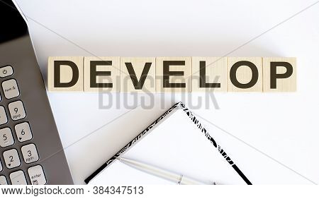 Business Concept Text On Wood Block Develop With Notebook And Laptor