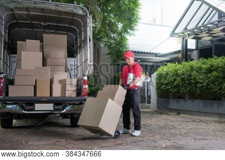 Asian Delivery Man In Red Uniform Delivering Parcel Boxes To Woman Recipient At Home