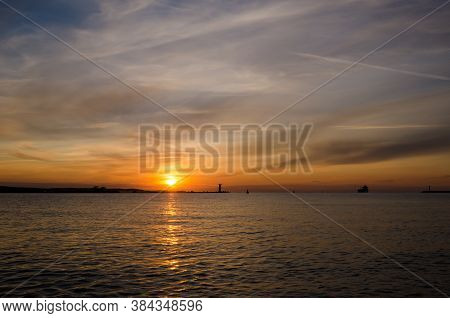 Navigation Sign On The Breakwater And Ship - Sunset On The Seashore In Swinoujscie