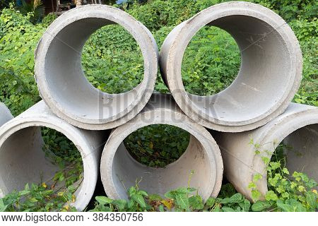 Close Up. Concrete Pipes Used For Drainage And Road Side In A Big City.