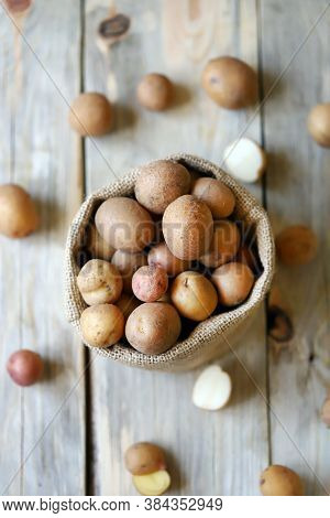 Selective Focus. Small Raw Potatoes In A Bag. Baby Potatoes. Rustic Style. Rustic Potatoes.