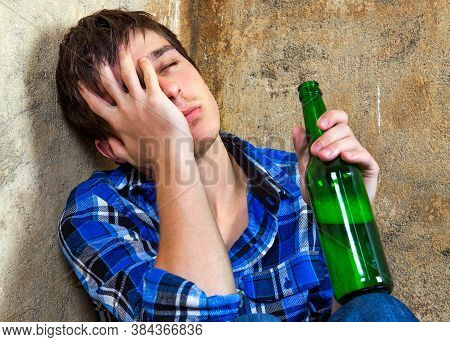 Sad Young Man In Alcohol Addiction With A Beer