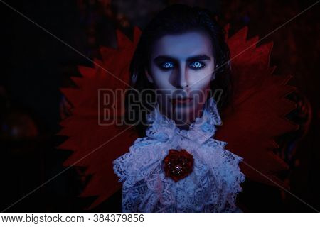 Portrait of an insidious vampire sneaking through the night in an old castle. Traditional vampire man. Halloween. Count Dracula.