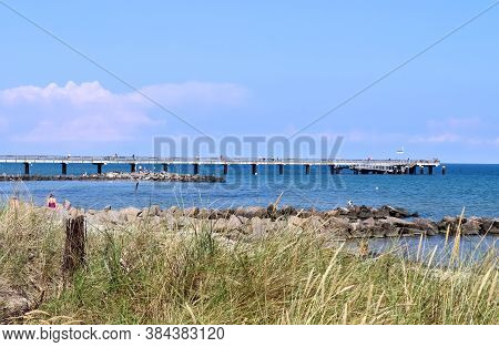 Sunny Beach Life With Some People In The Distance In Schoenberg In Northern Germany
