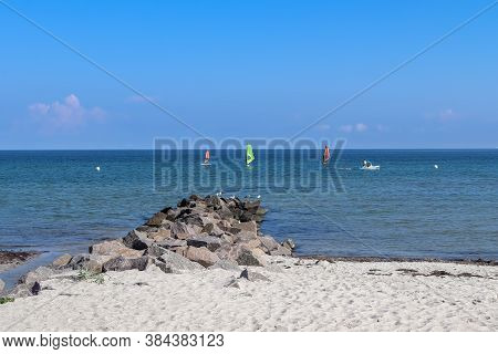 Sunny Beach Life With Some People In The Distance In Schoenberg In Northern Germany