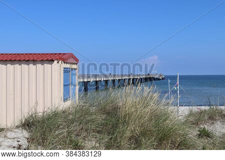 Sunny Beach Life With Some People In The Distance In Schoenberg In Northern Germany