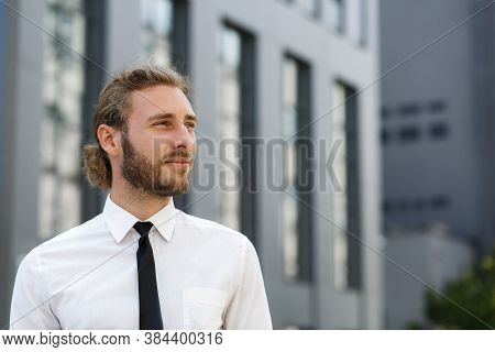 Portrait Of A Handsome Curly-haired Man, In A Business Style. The Astute Look Of An Attractive Busin