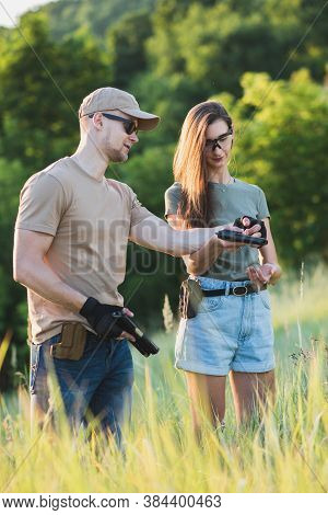 The Instructor Teaches The Girl To Shoot A Pistol At The Range