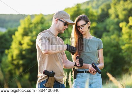 The Instructor Teaches The Girl To Shoot A Pistol At The Range