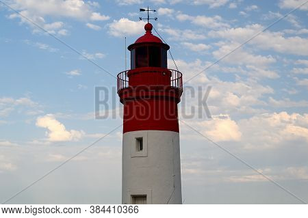 Lighthouse At The Entrance Of The Harbour