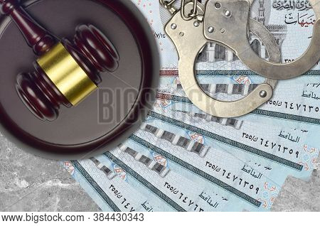 5 Egyptian Pounds Bills And Judge Hammer With Police Handcuffs On Court Desk. Concept Of Judicial Tr
