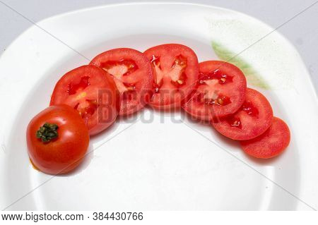 juicy red tomatoes in table cloth . caro background