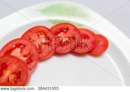 juicy red tomatoes in table cloth . caro background