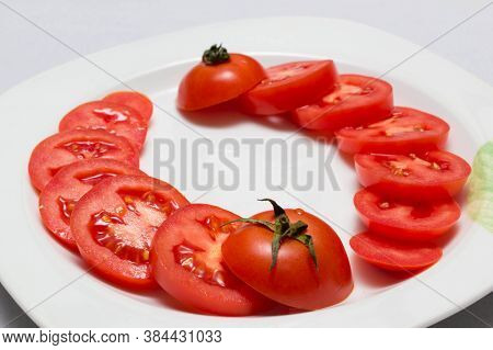 juicy red tomatoes in table cloth . caro background