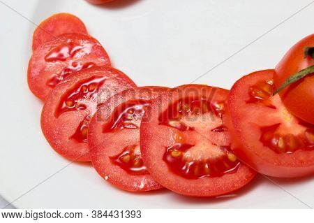 juicy red tomatoes in table cloth . caro background