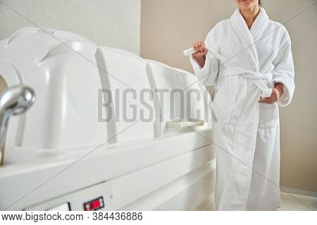 Unrecognized Woman Tying Her Bathrobe In Beauty Center
