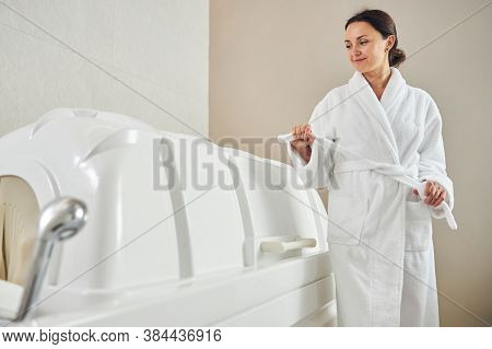 Pretty Lady Touching Her Bathrobe Belt In The Beauty Clinic