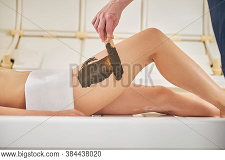 Cosmetologist Rubbing Scrub Into The Skin Of Woman