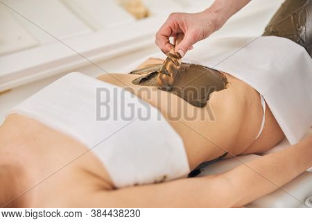 Belly Of The Woman With Body Scrub Being Spread On It