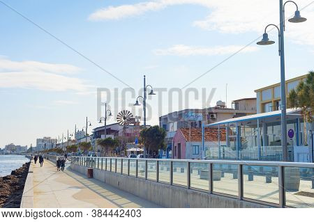 Larnaka, Cyprus - Feb 18, 2019: People Walking By Larnaca City Embankment With Typical Architecture 