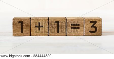 Wooden Cubes On White Background With One Plus One Equals Three