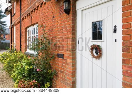 Front Of A Luxury Victorian Period House In England With Christmas Wreath On An Offwhite Wooden Door