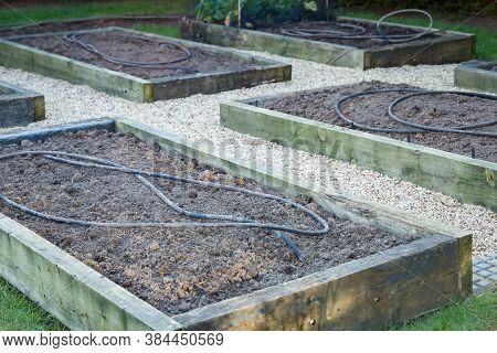 Empty Raised Beds In A Vegetable Garden In Spring Or Winter. Depicts Planning, Building Or Maintaini