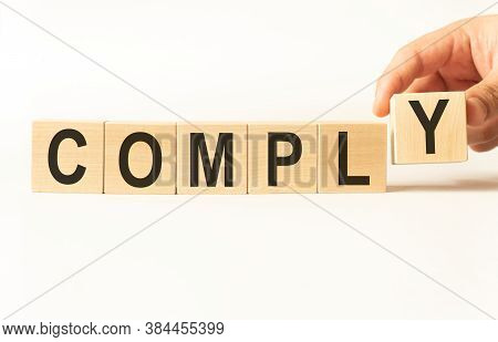 Word Comply. Wooden Small Cubes With Letters Isolated On White Background With Copy Space Available