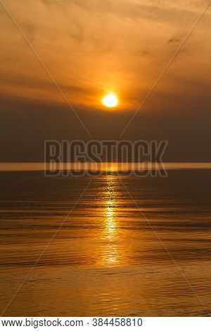 Sunset Over Sea With Sun Trail In Water